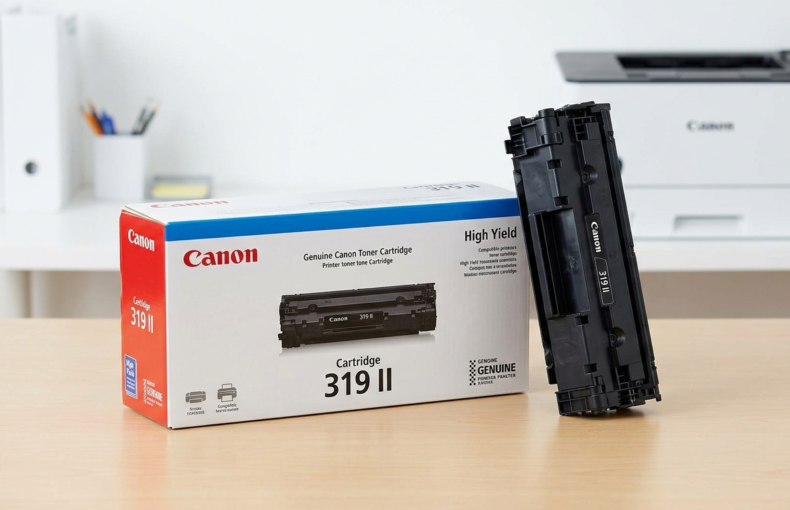 Canon Cartridge 319 II high yield toner box with the cartridge standing beside it on a desk