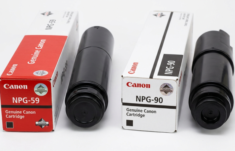 Genuine Canon NPG-59 and NPG-90 toner cartridges shown beside their packaging boxes